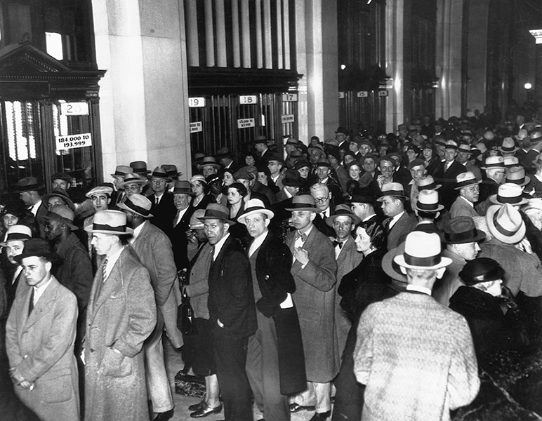 Thousands of people stand in line to receive 30% of their deposits during the National Banking Emergency of 1933.