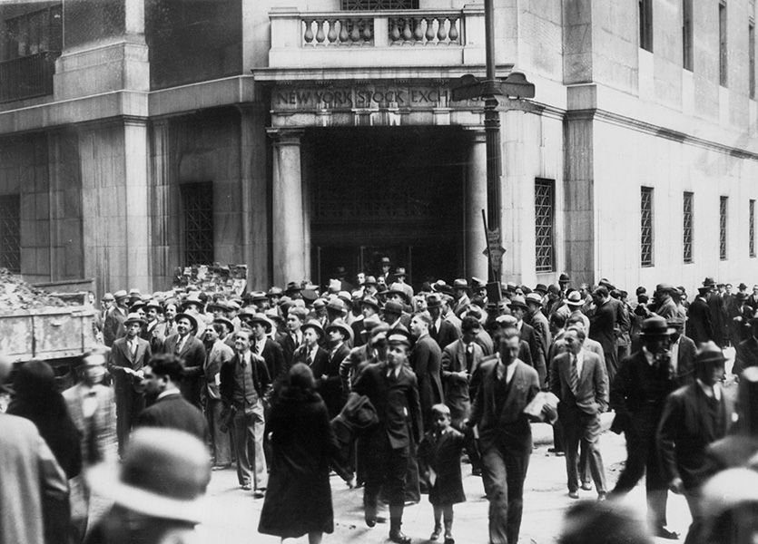 A crowd gathers outside the New York Stock Exchange following the 1929 crash.