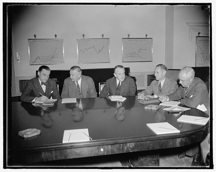 Federal Reserve Board members at the October 19, 1937 Meeting. In the photograph, left to right: M.S. Szymczak, John McKee, Ronald Ransom, Vice Chairman; Marriner Eccles, Chairman; and Chester C. Davis.
