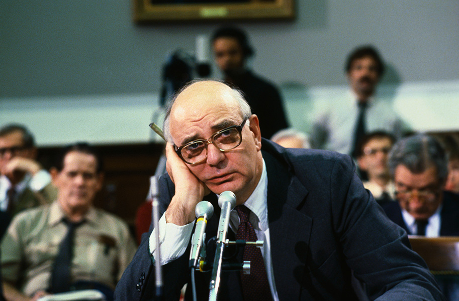 Chairman of the Federal Reserve Board of Governors Paul Volcker holds his head in his hand at a meeting in Washington, D.C.