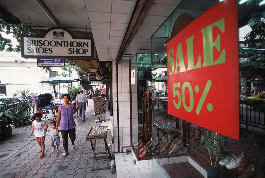 A Bangkok, Thailand, shop offers 50% off in a desperate attempt to lure customers who have lost their spending power after the economic crash of 1997.