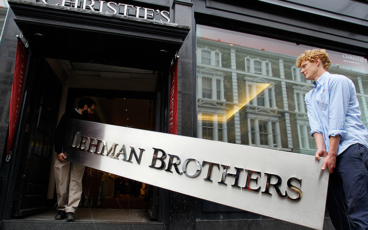 Two men carry the Lehman Brothers corporate sign to an auction house in London.