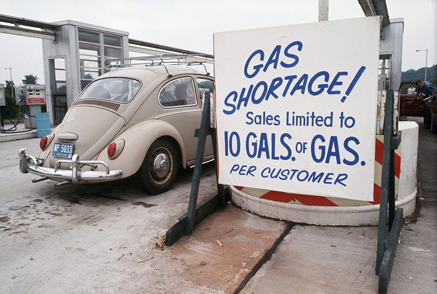 Sign reading “Gas shortage! Sales limited to 10 gallons of gas per customer” posted at a filling station during the energy crisis